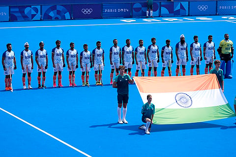 Players of India line up for their national anthem